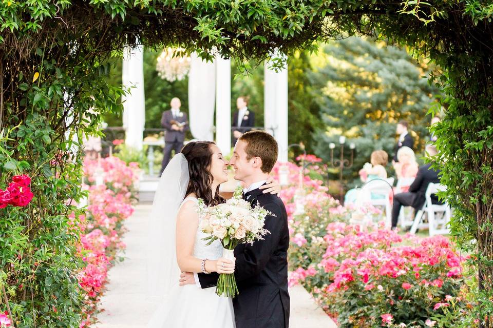 Newlyweds kissing under the arch