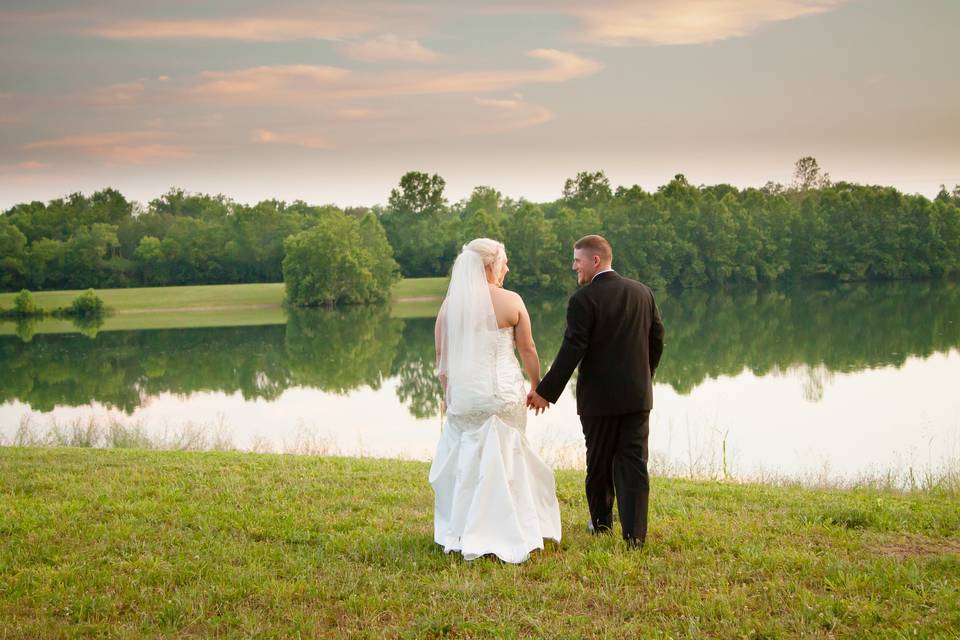 Couple walk along the green grass