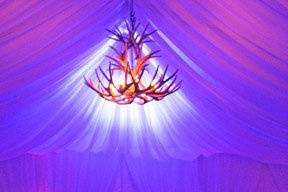 Backlighting of custom fabric treatment in a tent and uplighting of tent legs