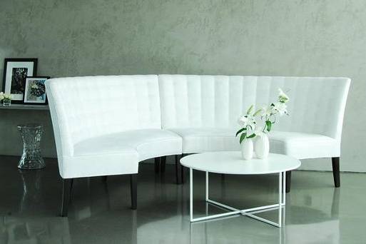 Luxurious tufted banquette in a white ultra-suede.  Use for lounge seating as shown, or with our Hourglass Table for dining.  This image was shot at The Glass Houses in NYC.