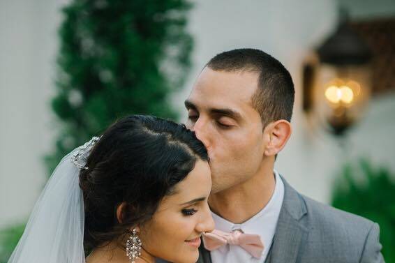 Groom kissing his bride