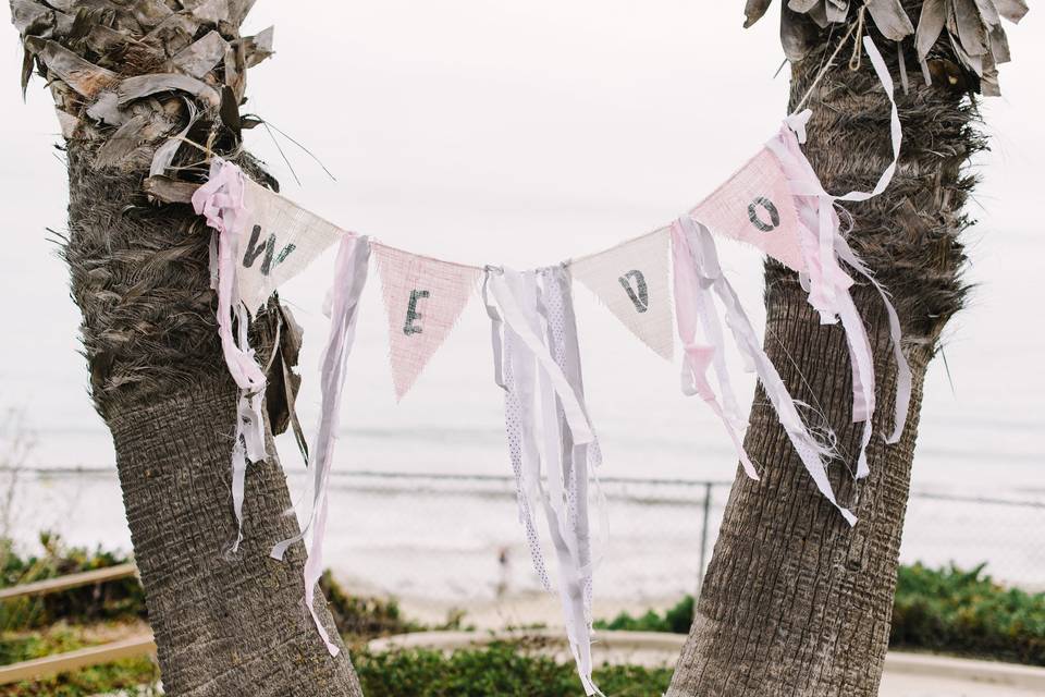 Pennant flag strung between two palm trees, served a perfect backdrop for the Ceremony.