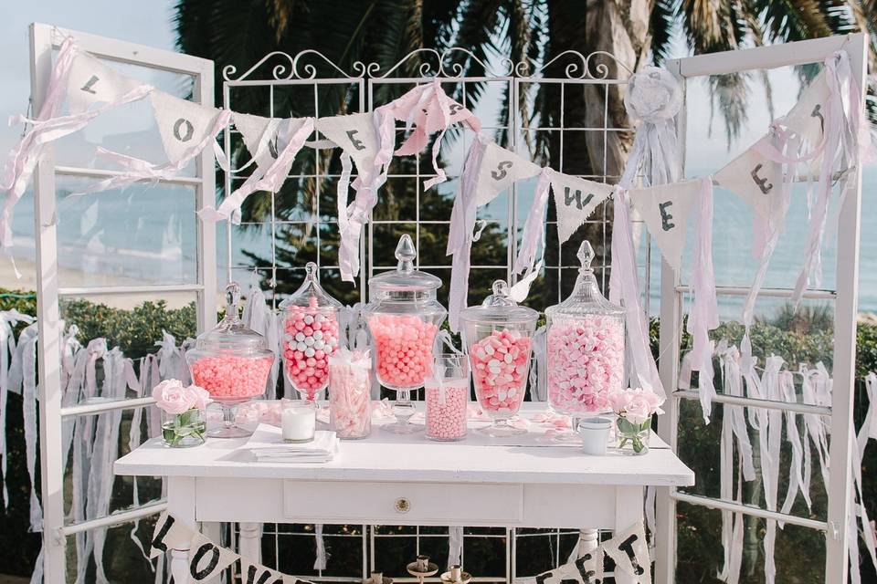 Candy Bar looked adorable with bright pink offerings in glass dispensers.