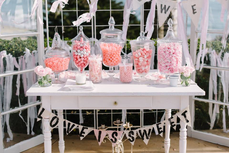 Candy Bar looked adorable with bright pink offerings in glass dispensers.