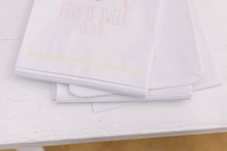 Close up of the Candy Bar displayed on a white chippy table. A pennent flag proclaimed: 'Love is Sweet.'