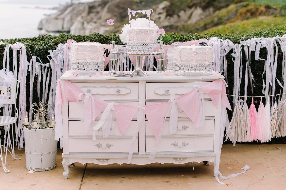 The cake table was a beautiful dresser and made an excellent display for the three cakes. Cake topper was miniature pennant flags. Lovely!