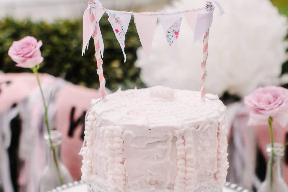 The cake table was a beautiful dresser and made an excellent display for the three cakes. Cake topper was miniature pennant flags. Lovely!