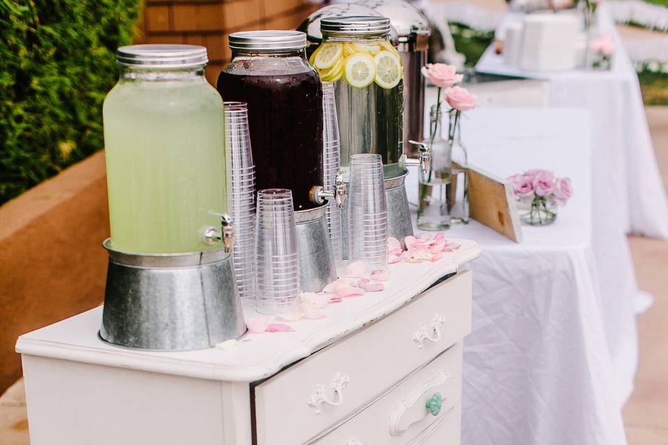 Lemonade, tea and water were offered on top of an antique dressor.