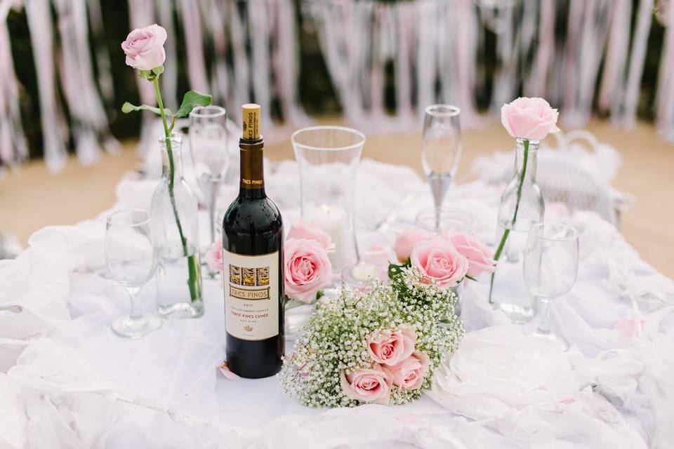 The sweetheart table was framed by a shabby chic arch decorated with a rose garland and crystal chandelier.