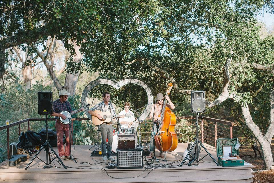 The McCoy Tyler Band played their American Folk style music on a built in stage with a giant heart marquee built by the Bride's Father.