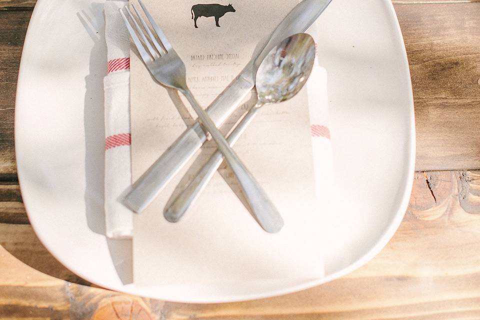 Tea towel napkins also served as guest favors. Beautiful menus were printed on natural, brown paper. Plates and silverware rented from A Perfect Day.