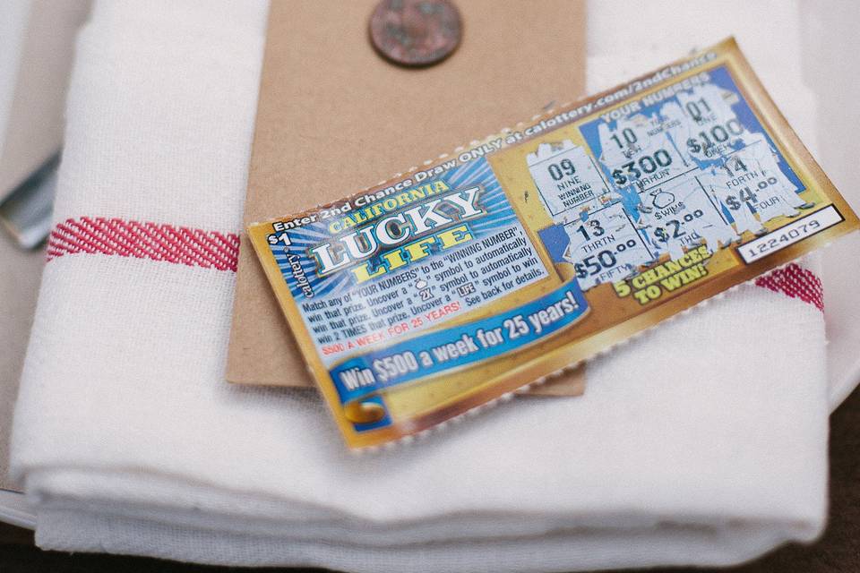 Fabulous favors were a lucky penny and scratcher ticket tucked inside the tea towel napkin.