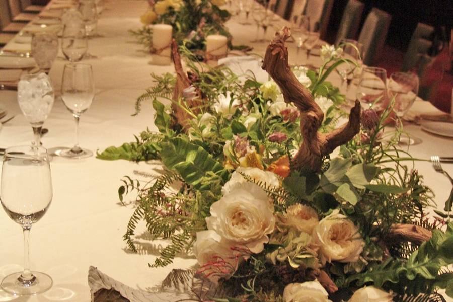 dinner for 30 Brasserie 8, NYC
winterstroll in the woods, driftwood overgrown with maidenhair ferns, frittaleria, white cabbage roses, jasmine and lady slipper orchids
create a lush and elegant table runner, the center section was made of dancing poppies for a bit of whimsy