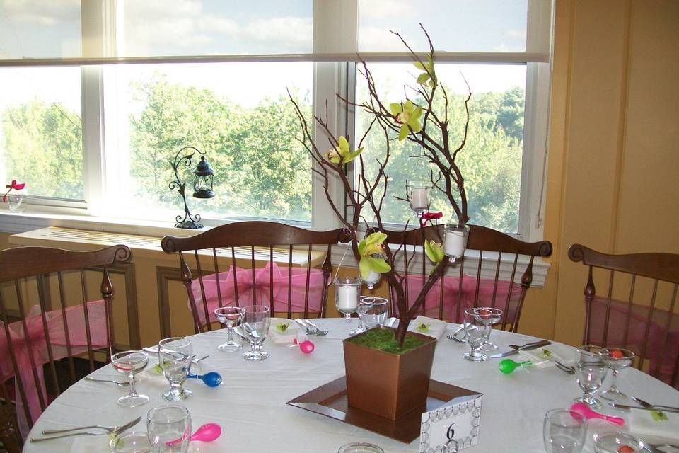 This centerpiece featured pink flowers as the primary color.  The same piece used green or yellow as the primary color on other tables.