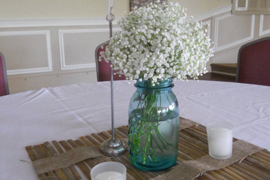 It doesn't get any sweeter or simpler than this!  A bouquet of Baby's Breath graces an antique blue mason jar...