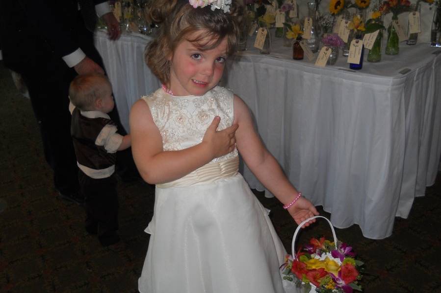 The adorable flowergirl liked the placecards attached to antique bottle/vases!
