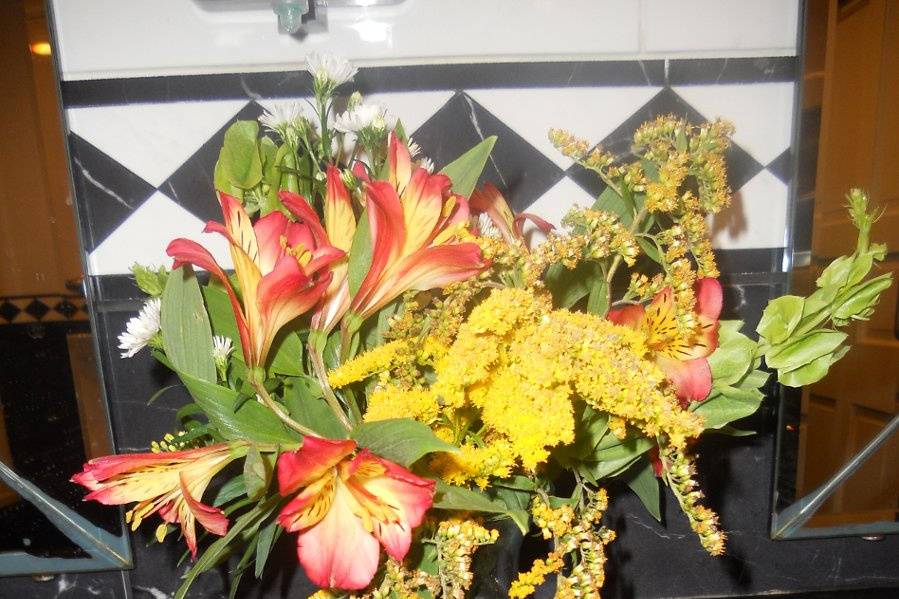 And a vase of yellows with red accents was placed in the Men's Room.