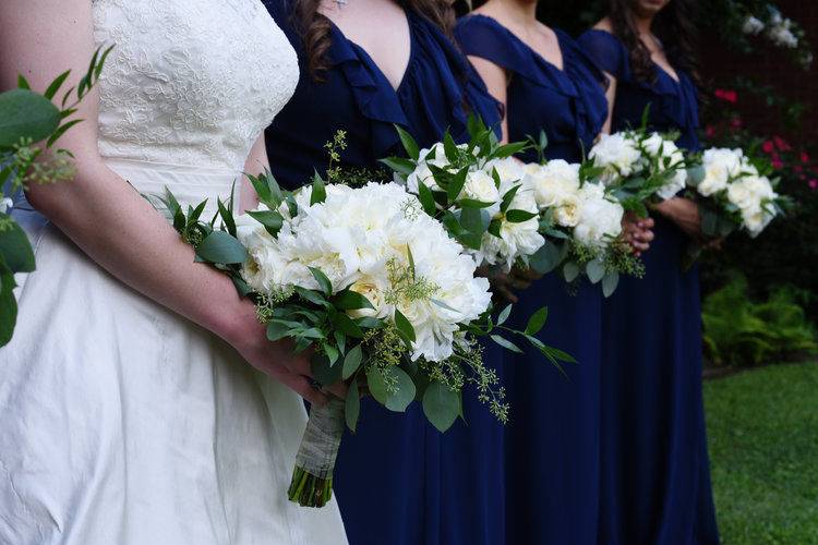 The bride with her bridesmaids holding their bouquet