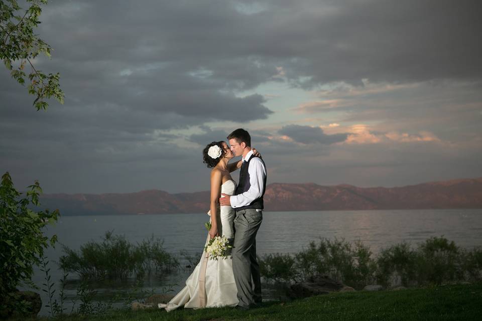 Newlyweds kissing with a view