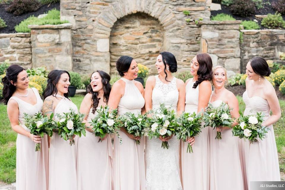 Bride and her bridesmaids sharing laughs