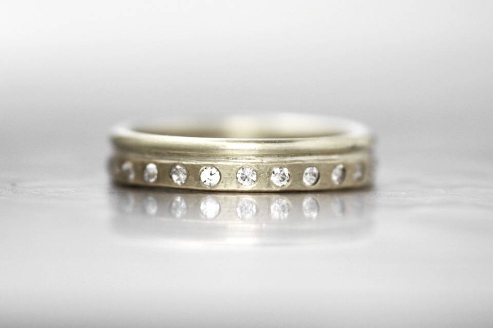OSTERLINGThis unique diamond wedding band creates dimension with the opposing rounded and squared off edges. The signature Wanderlust texture creates a subtle and organic feel that will wear perfectly over time.