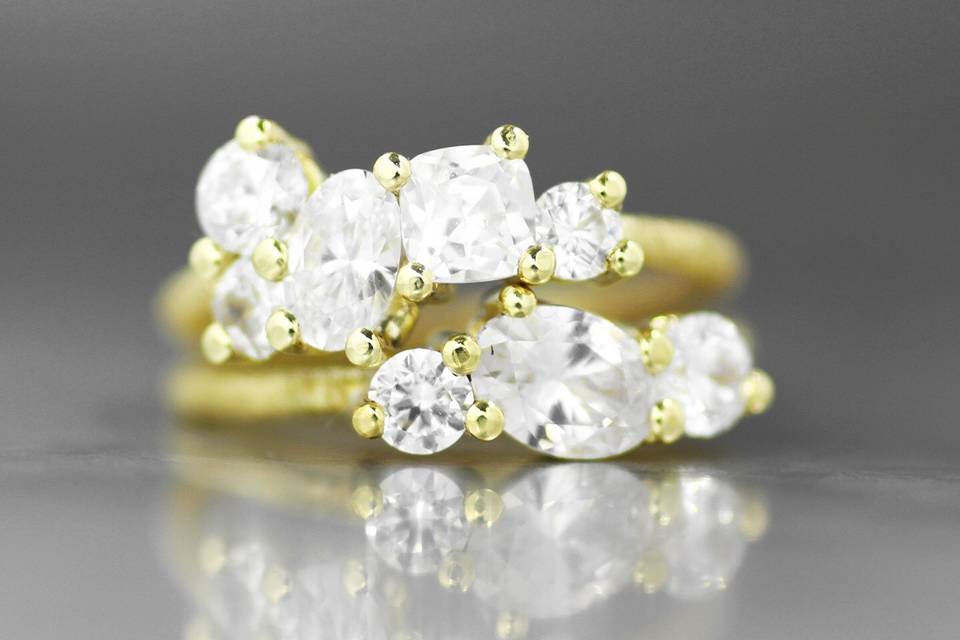 The Cortona and the Antigua engagement rings, shown in 18k yellow gold