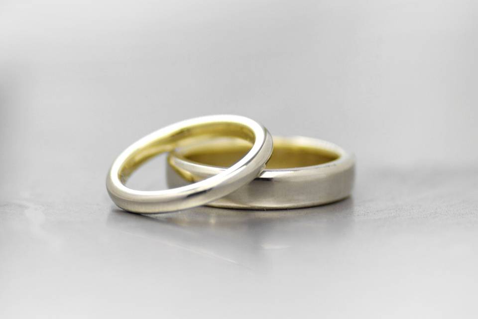 White gold his and hers wedding bands with yellow gold linings