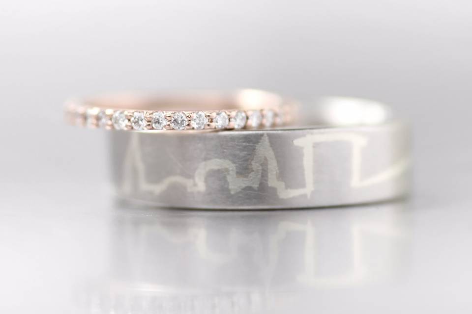 A rose gold eternity band with a custom Cleveland skyline wedding band!