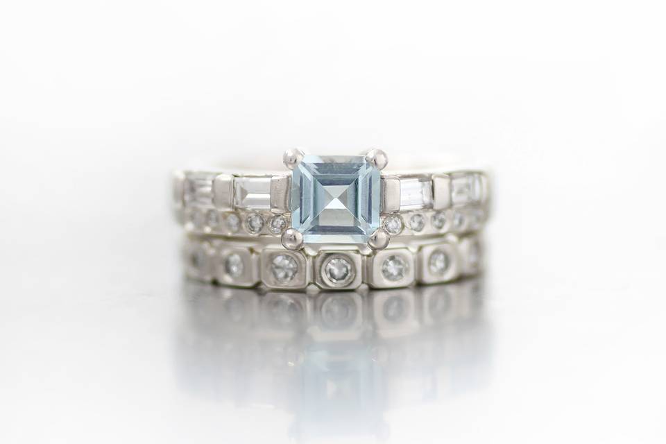White gold engagement ring and wedding band using heirloom diamonds and a step cut aquamarine