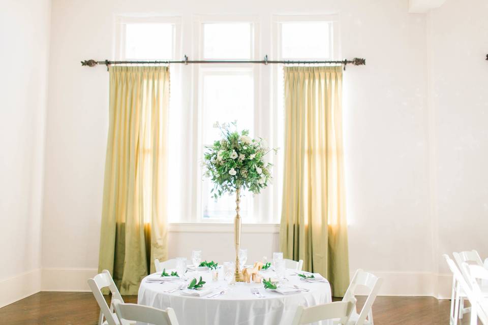 White round table setup with centerpiece