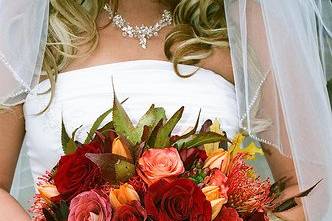 Fall colored roses with autumn foliage create a rich and beautiful bridal bouquet