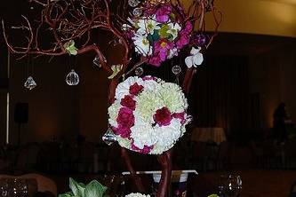 Manzanita branches adorned with fresh floral balls, crystals and candles