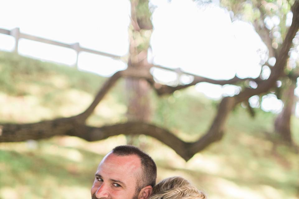 Newlyweds by the trees