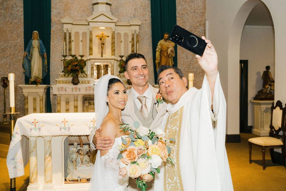 Priest doing selfie w/couple