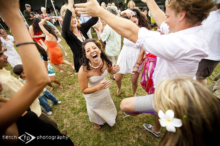 Newlyweds and guests dancing