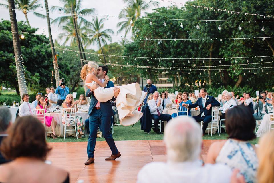 Groom carrying his bride