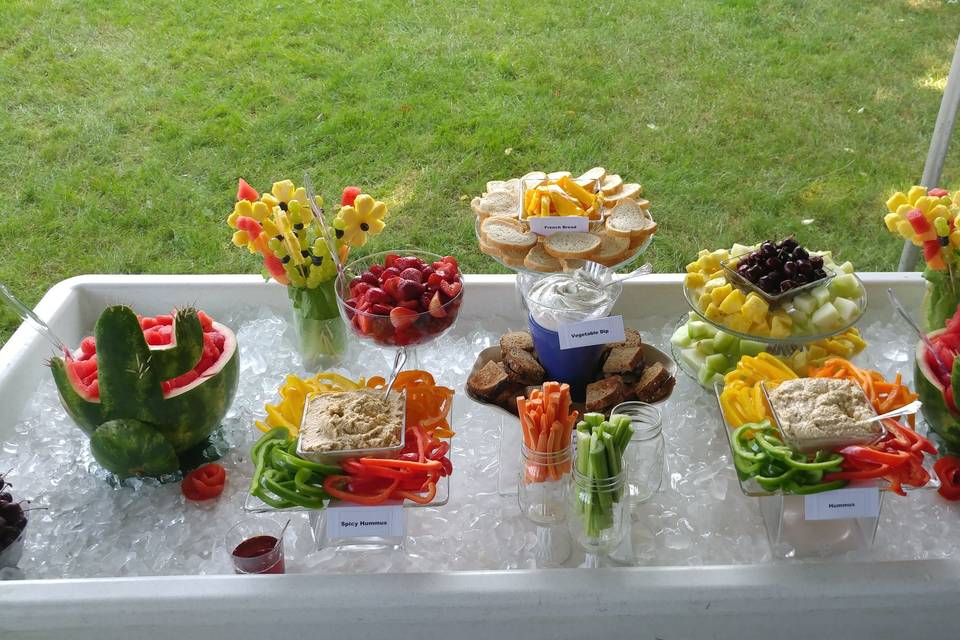 For Vegetarian bride, a happy hour ice bar with variety of fruits, vegetables, hummus, veggie dip and eggplant sandwiches with garlic basil aioli