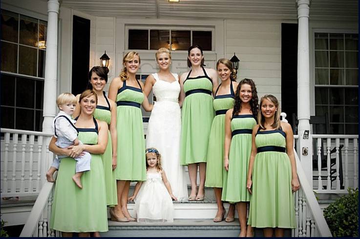 Bride, bridesmaids, and flower girl by the steps