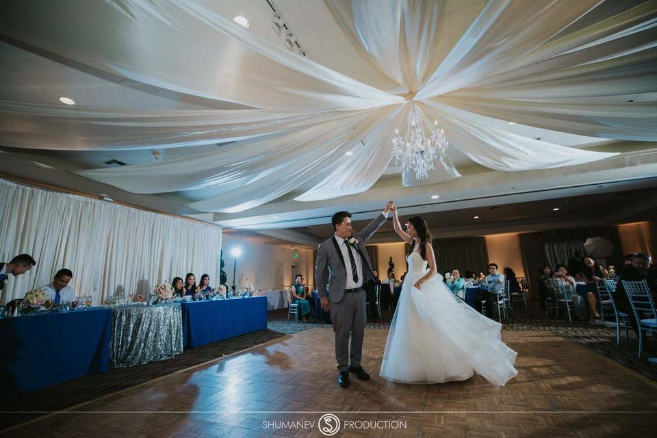 Elegant wedding reception with fabric draping and chandelier