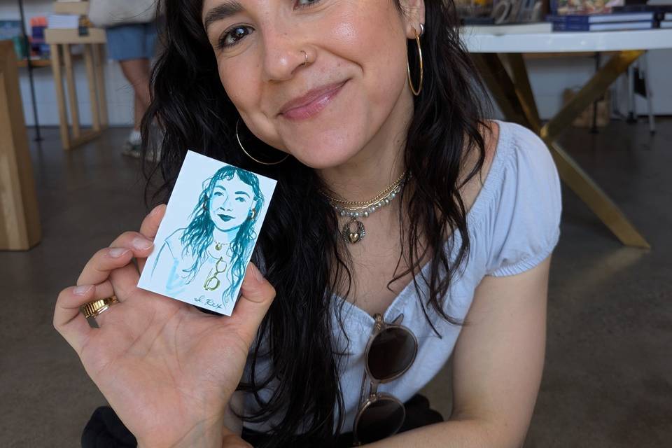 Guest holding their portrait