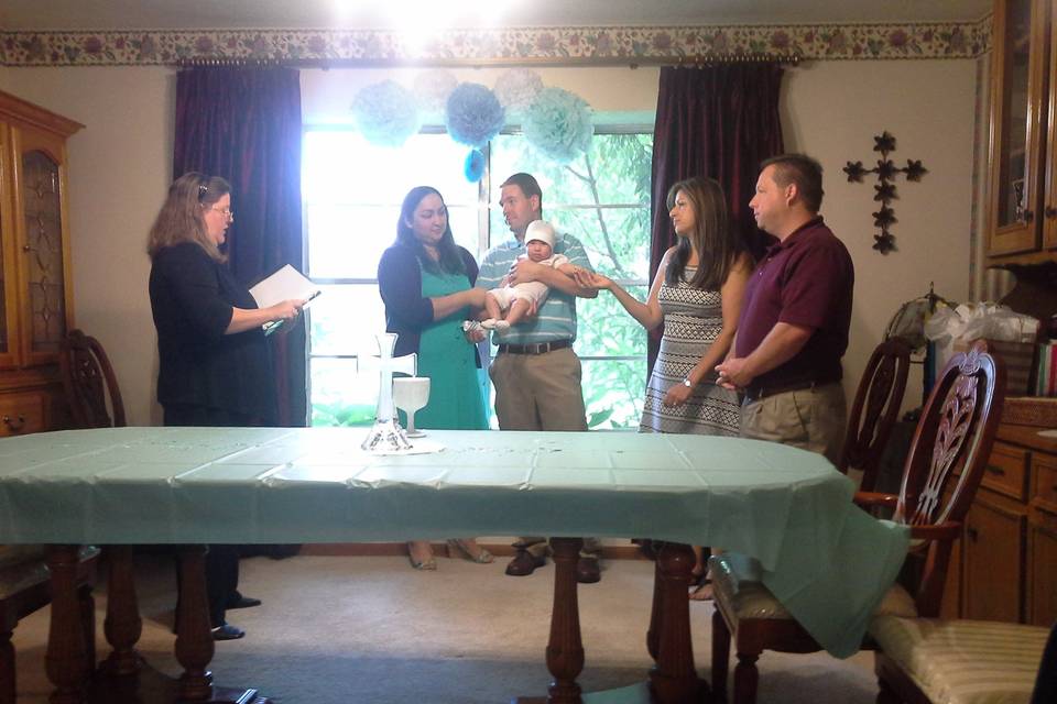 Baby blessing ceremony with roses at the family's home.