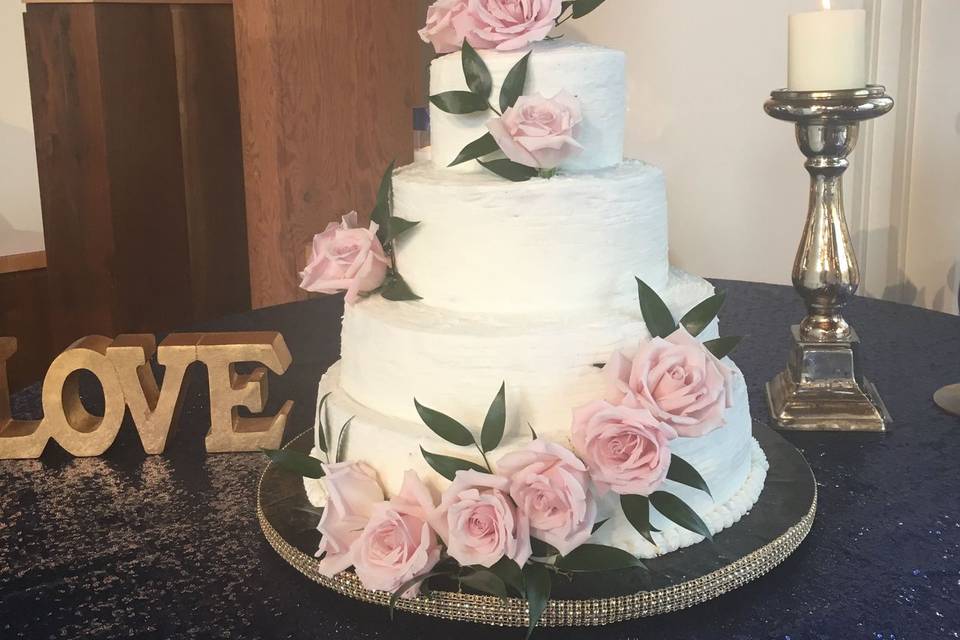 Rustic wedding cake with cascade of roses