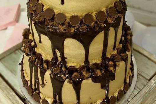 Groom's Table. Chocolate Cake with Peanut Butter Buttercream Frosting. Topped with Chocolate Ganache and Reese Cups.