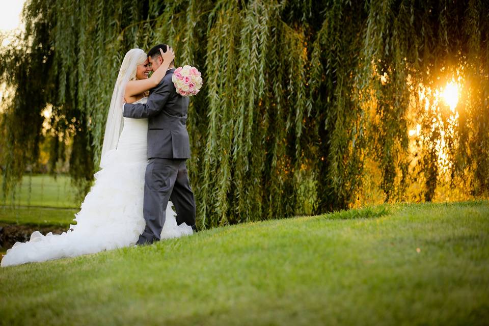 Newlyweds by the trees