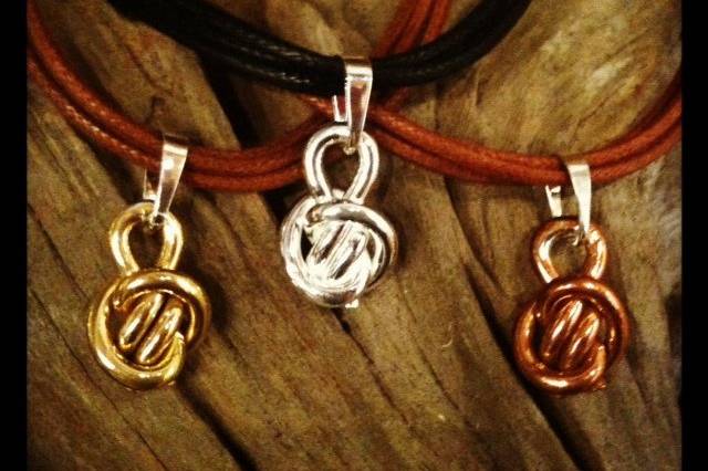 Crucian Knot pendants (from left to right) made in Brass, Silver, and Copper.