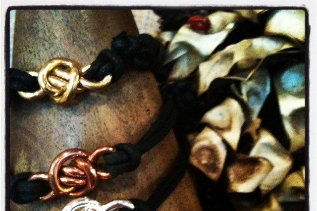 Crucian Knot cord bracelets (from top to bottom) Brass, Copper, and Silver. These cord bracelets adjust to any size your party guest might need.