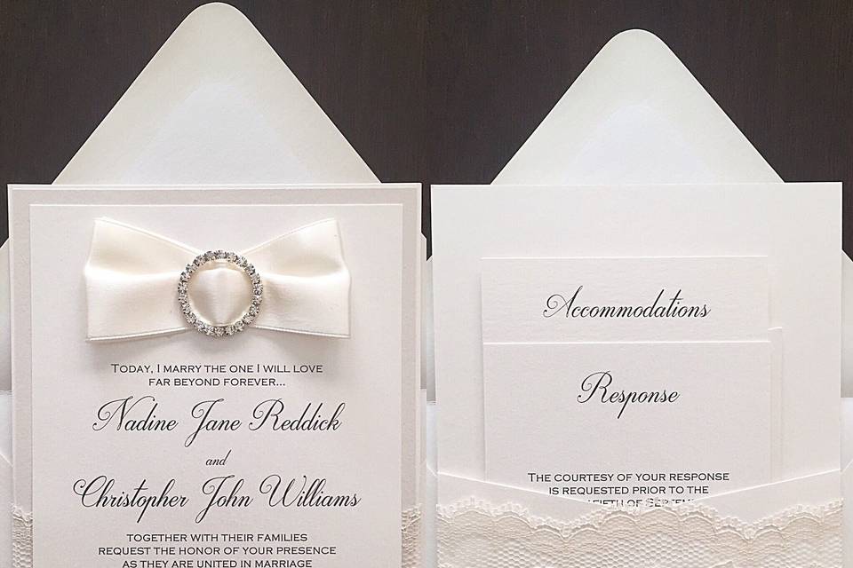White invitation with ribbon and lace