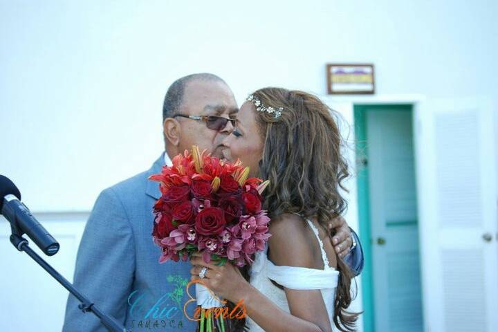 Assortment of red and burgundy roses, cymbidium orchids and casa blanca lilies for bridal bouquet