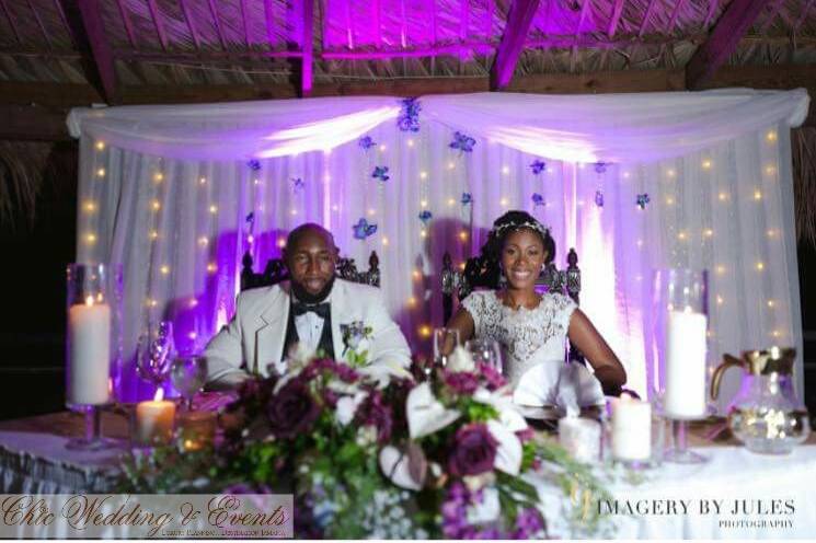 Sweetheart table with fair lights and purple wedding decor