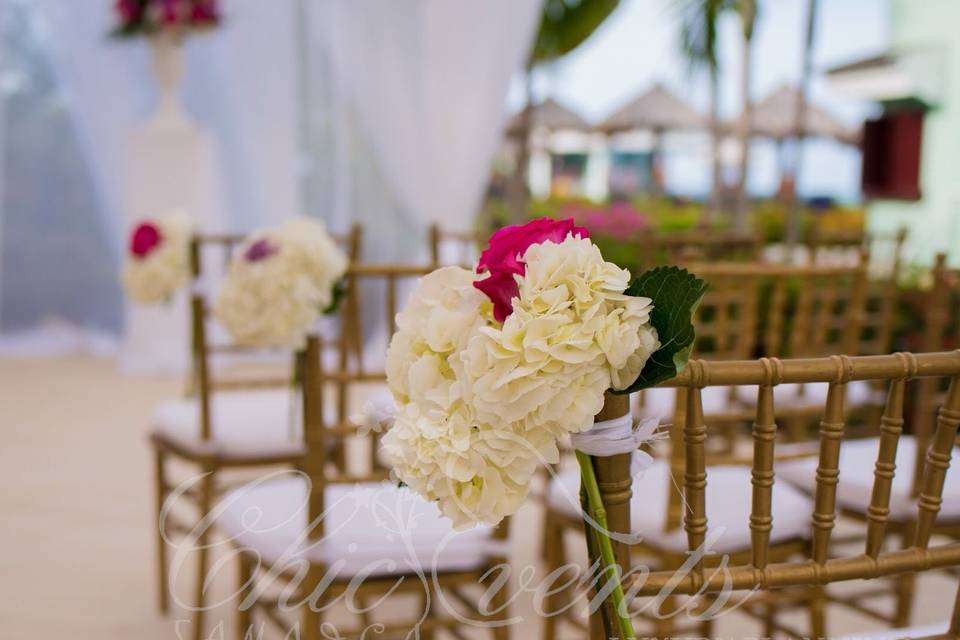 Aisle marker of white hydrangeas and fuschia roses